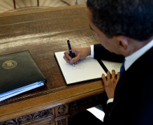 1024px-Barack_Obama_signs_at_his_desk