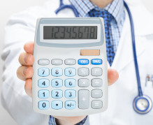 Doctor holding calculator in hand - health care concept
